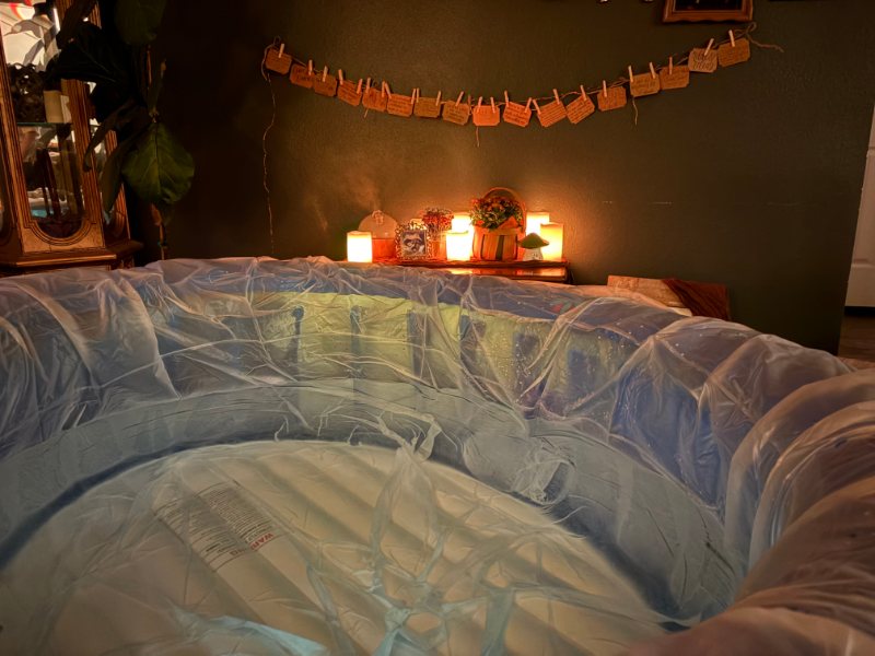 A birthing pool prepared in a softly lit room for a home birth